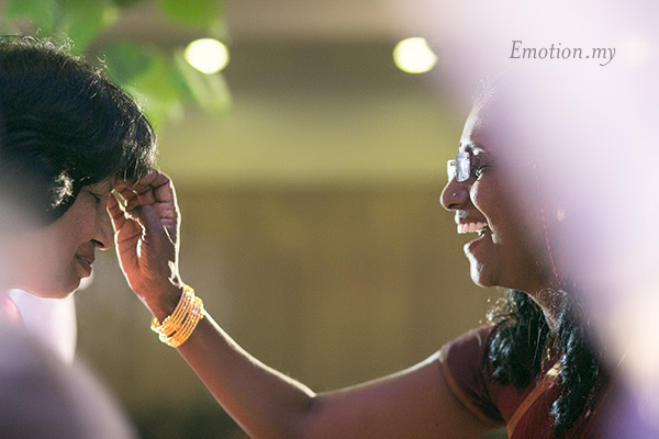 Both parents bless and sprinkle scented water on each other. Indian wedding in Malaysia. Photo by Emotion in Pictures