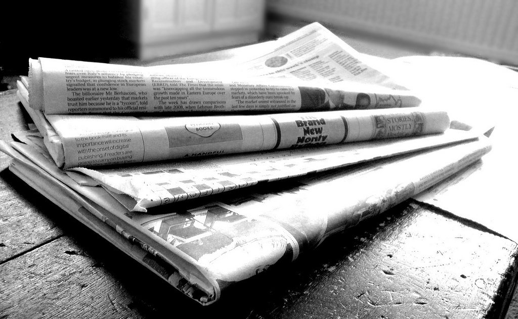 A pile of newspapers out front is a sure sign you're not at home. Photo by Flickr user Jon S