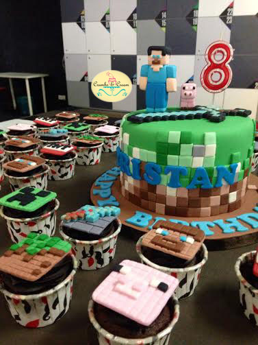 Steve, mini pig and sword Minecraft cake, with assorted Minecraft cupcake designs by Crumbs and Cream