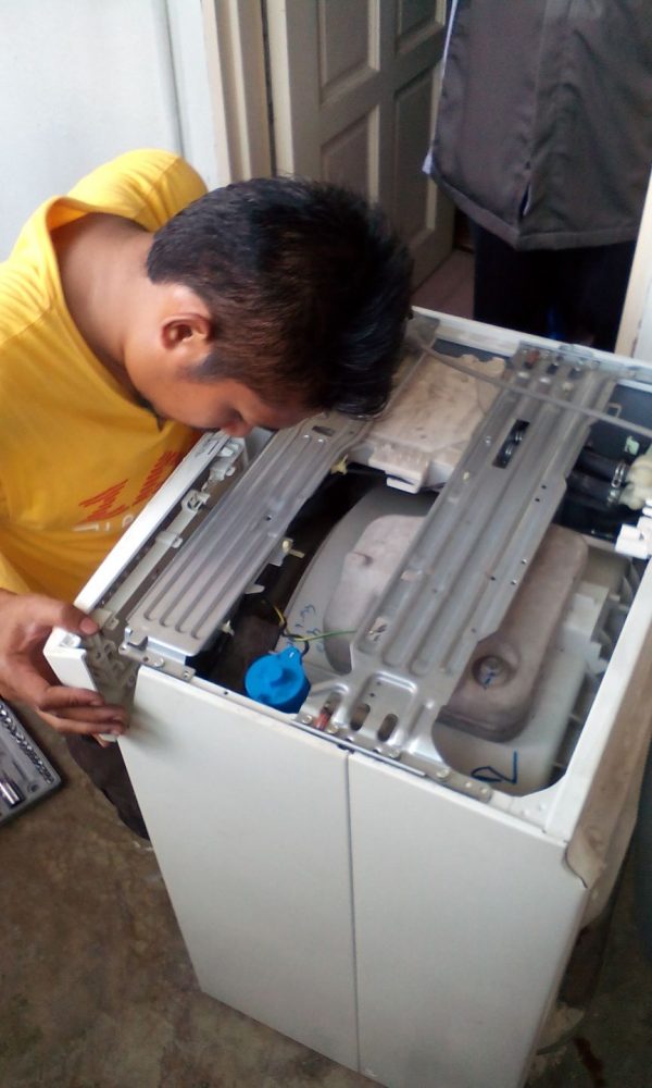 Repairing washing machine by Zam Handyman. Source. 