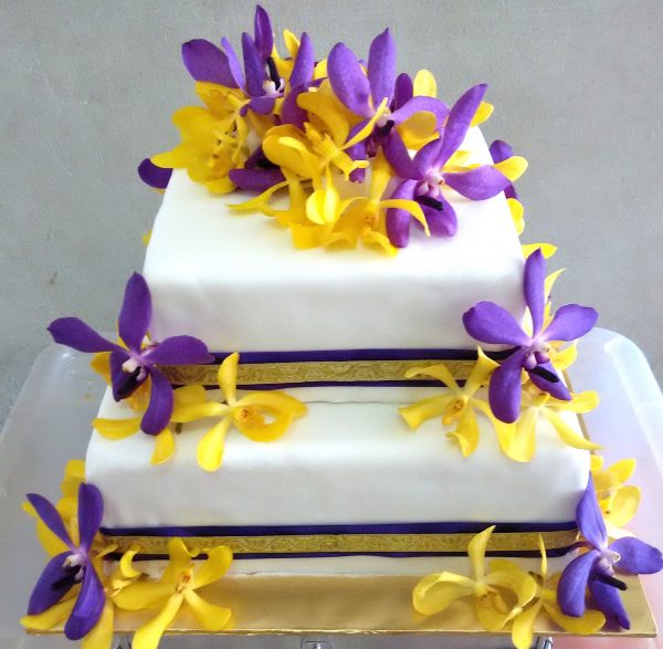 3-tier wedding cake with orchid flowers by Simple Delights. Source. 