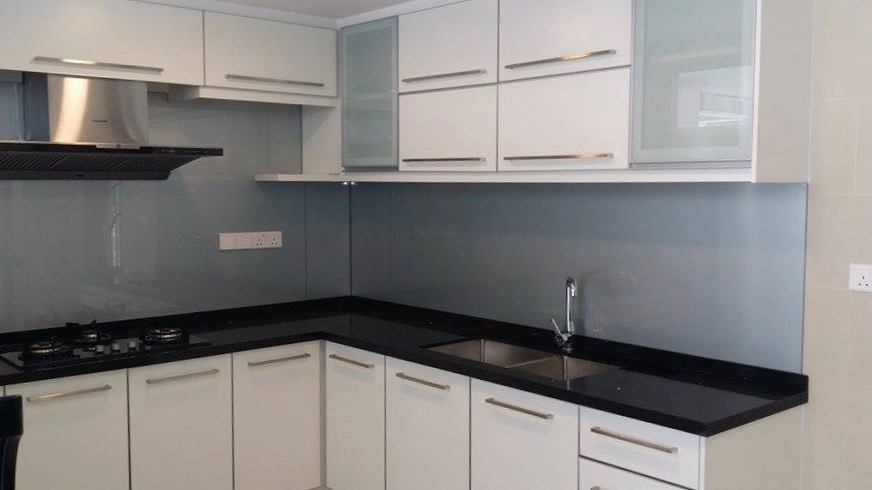 Black countertop and white kitchen cabinets. LNNS Construction & Renovation & Primo Interiors. Source. 
