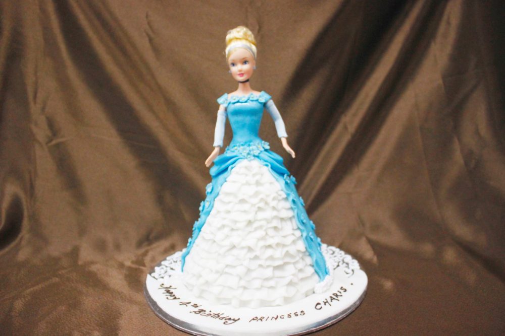 Elsa-themed doll cake in blue. Made by: Temptations Cakes. Order in Singapore at Recommend.sg
