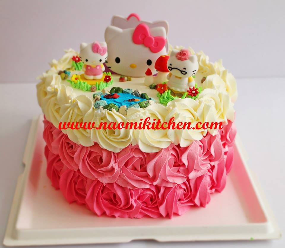 Hello Kitty figures on top of a round cake nicely frosted with rose buttercream. Made by: Naomi Kitchen. Source
