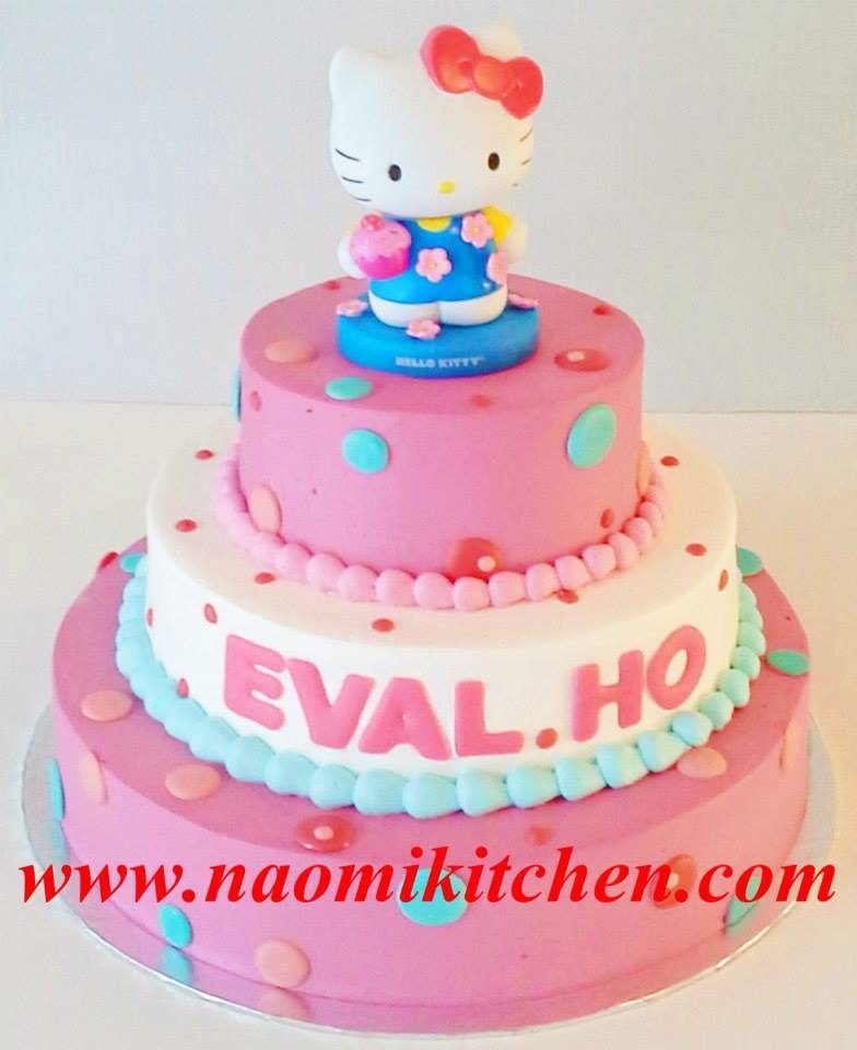 A three-tiered round cake with simple designs and a Hello Kitty topper. Made by: Naomi Kitchen. Source