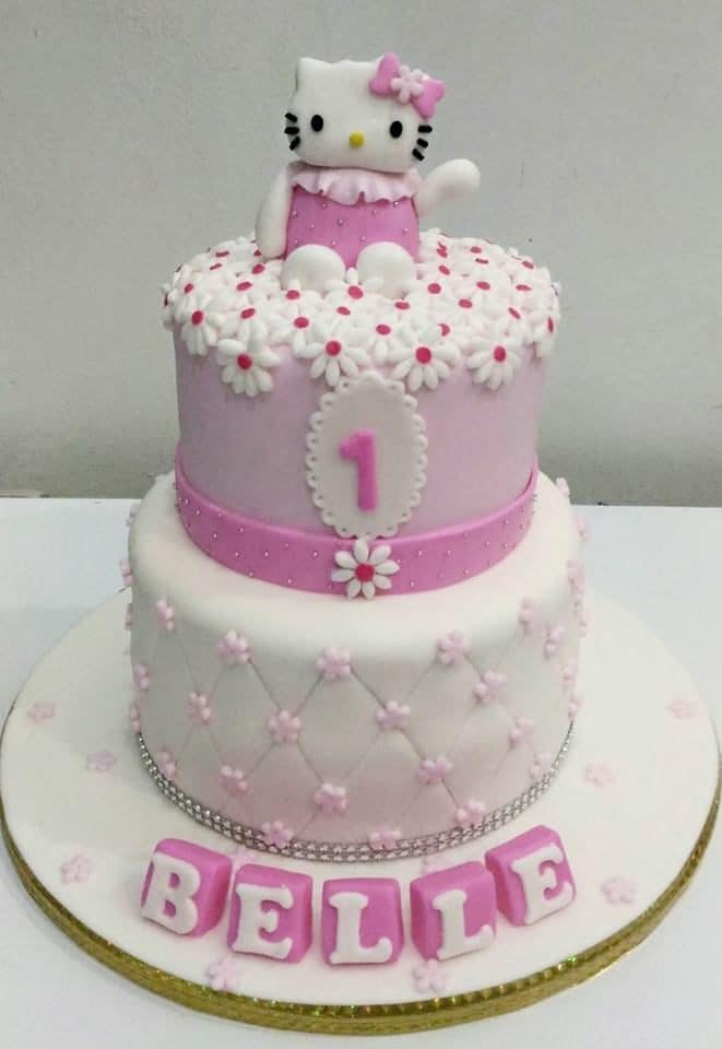 This cake looks very elegant with the stacking two tiers with fondant icing. Not to mention the addition of flower cuts on top. Made by : Eats & Treats Bakery.Source