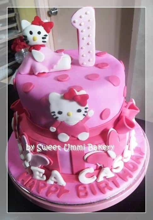 Stacked, round-shaped pink cake with dotted fondant decoration on its covering seems cuter with an addition of pink bow around its side. Made by: Sweet Ummi Bakery .Source
