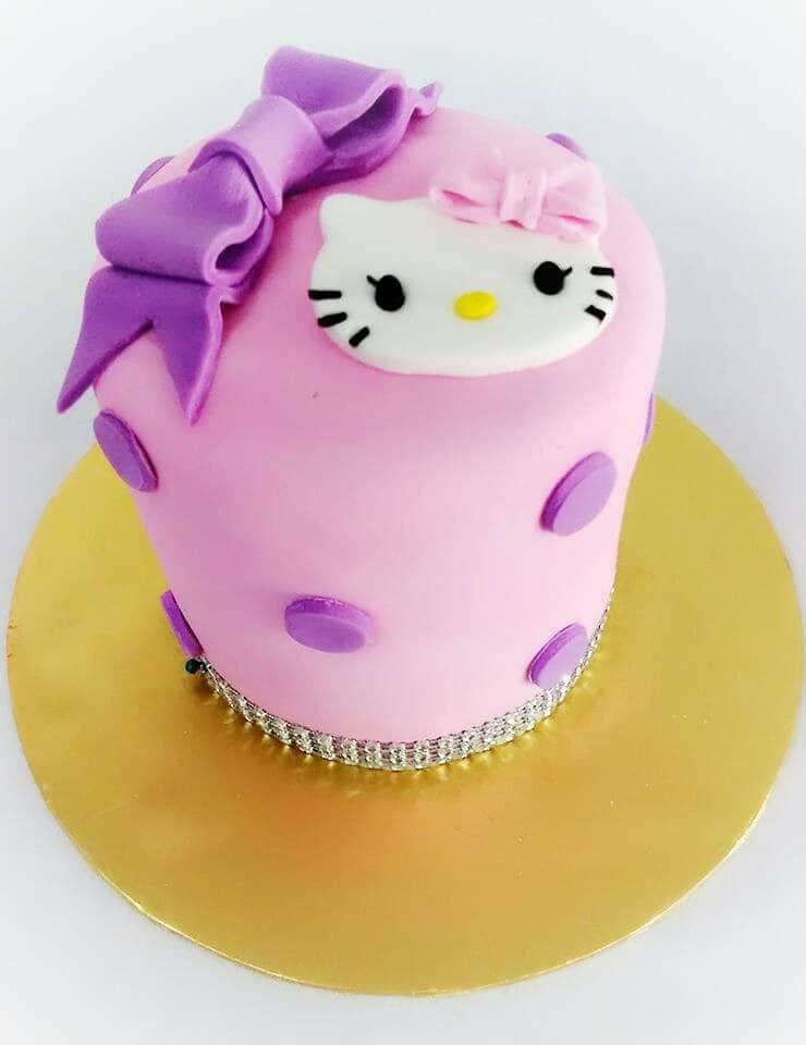 Simplicity at its best with tall round cake covered with a layer of fondant icing, decorated with purple dots, a big ribbon, Hello Kitty cutout on top, and edible diamonds beneath. Made by : Eats & Treats Bakery.Source