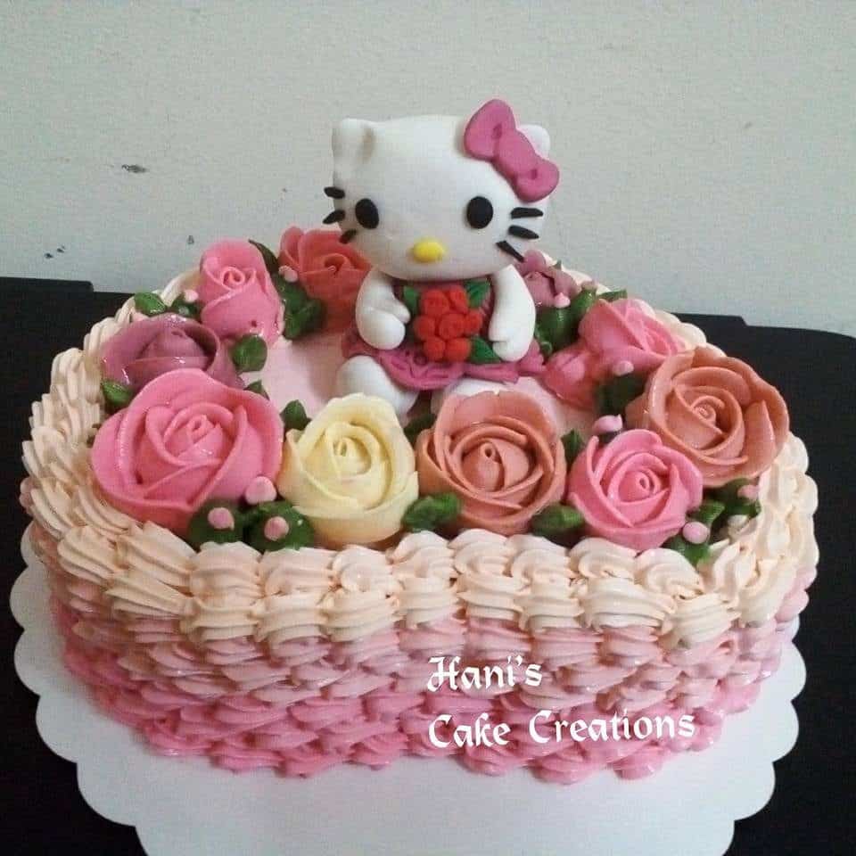 Heart-shaped cake with rose buttercream frosting on top will make your Hello Kitty topper looks like it sits comfortably in a flowery garden. Made by:  Hani's Cake Creations.Source
