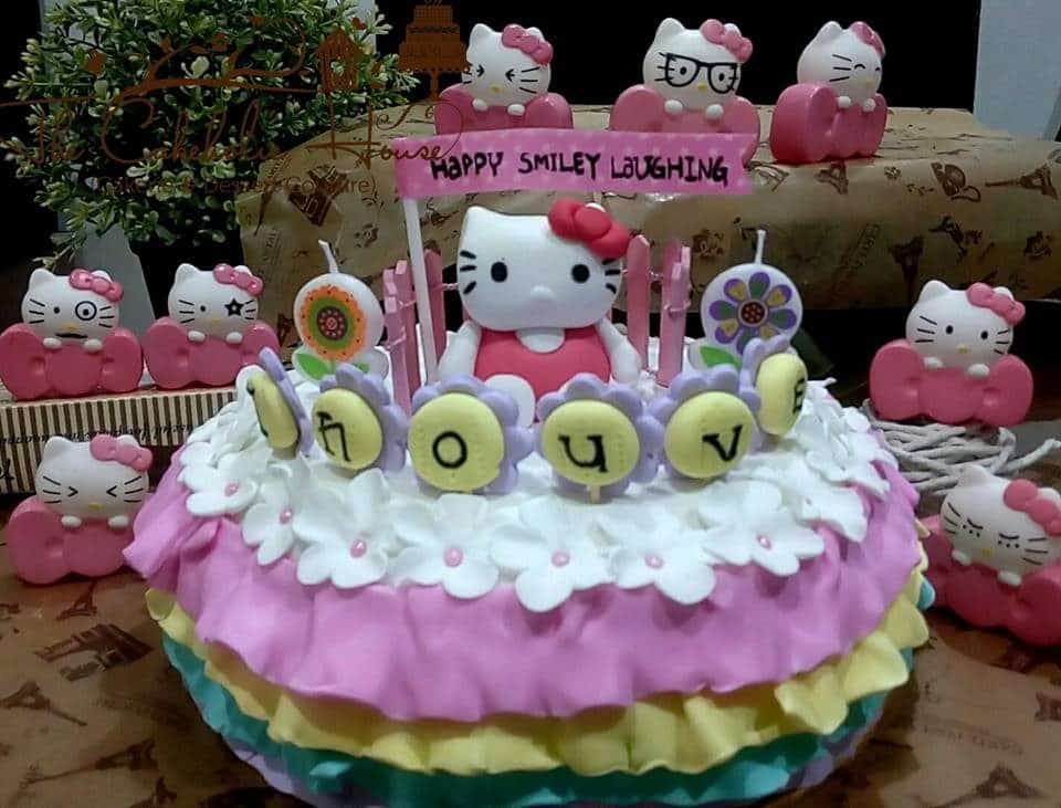 Round cake with three layered fondant icing and flower decoration on top, combined with a Hello Kitty topper.Made by: The CakeHolic House. Source