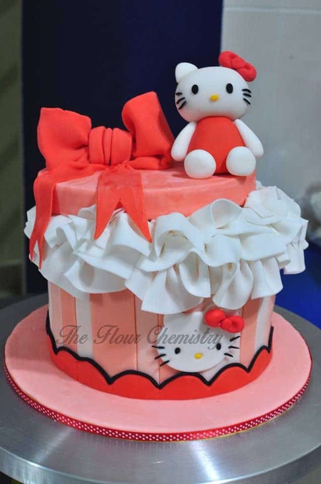 Redder tones in this Hello Kitty cake works for those who don't prefer pink. Made by:  The Flour Chemistry .Source