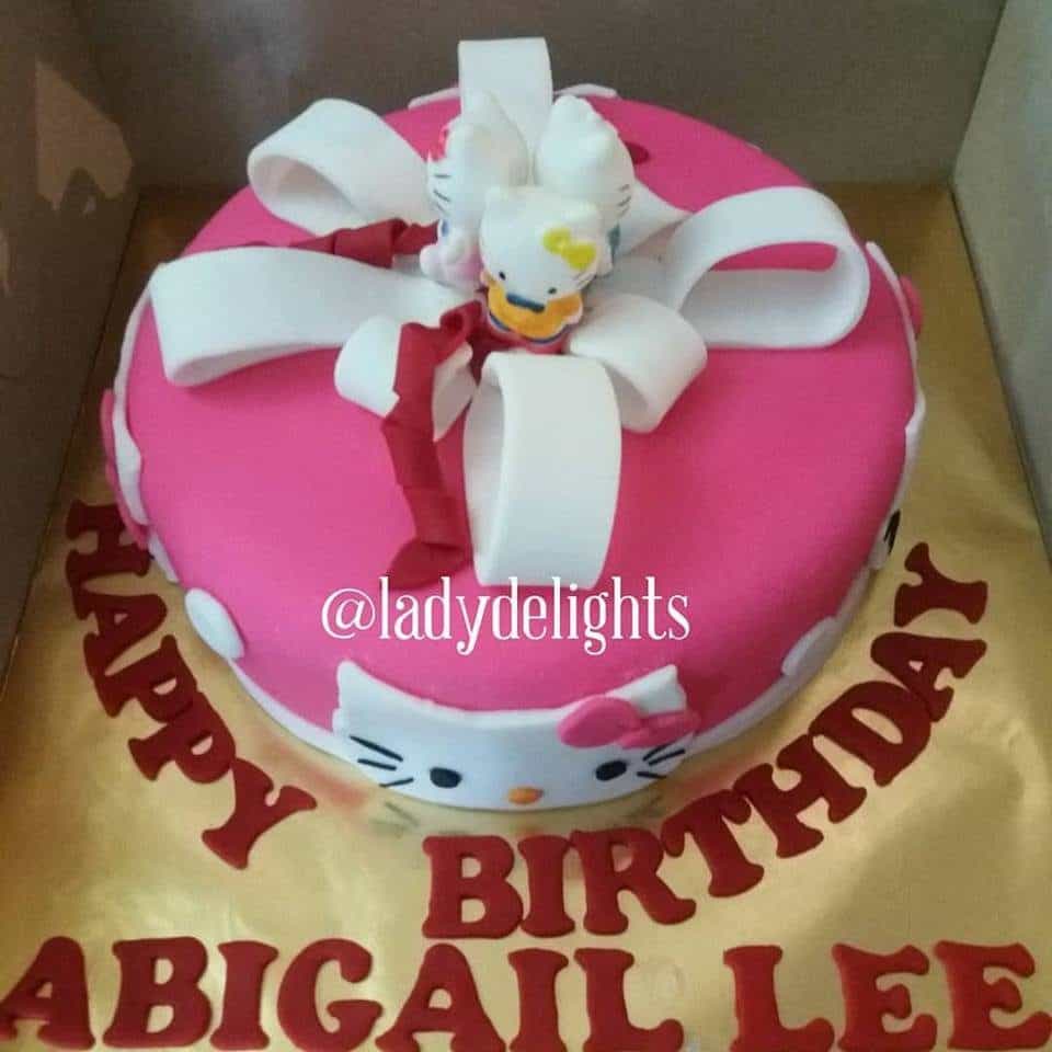 A simple round cake with fondant decoration and a group of three Hello Kitty toppers.Made by: Ladydelights Bakery .Source