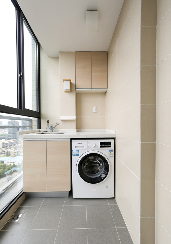 Add a counter above the washing machine to create folding space