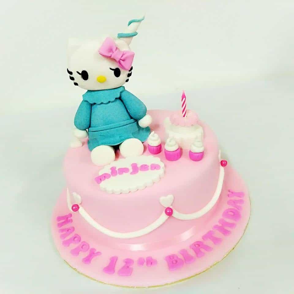 A round cake covered with soft pink fondant icing and simple design is a nice base for a medium size Hello Kitty topper. Made by : Eats & Treats Bakery.Source