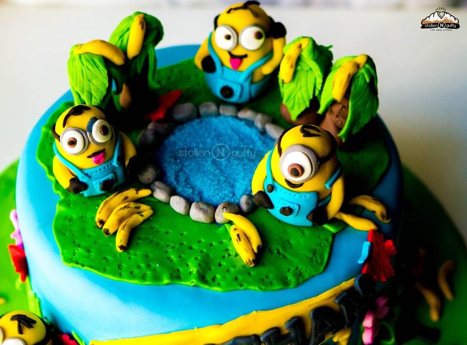 Three edible Minion figurines on a round cake nicely decorated with fondant detailings.Made by: Stollen N Guilty .Source