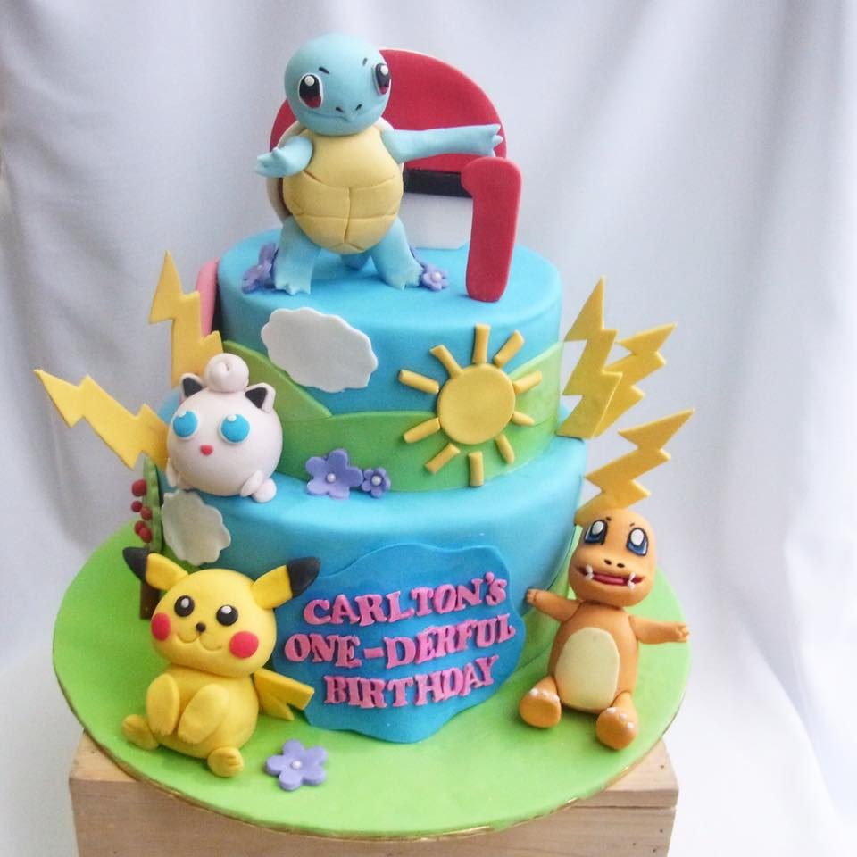 A two-tiered Pokemon cake neatly wrapped with fondant and decorated with edible Squirtle, Jigglypuff, Pikachu and Charmander. Custom cake by Corine & Cake.Source
