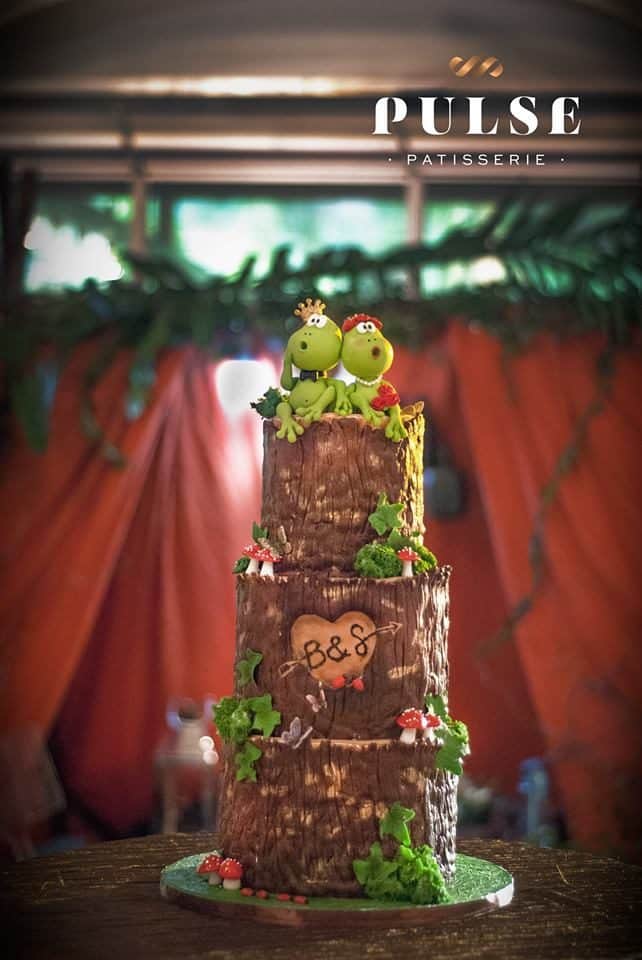 The three-tiered wedding cake that was handpainted by the cake artist to make it look like a wood log is perfect for a back-to-nature themed wedding.  Made by: Pulse Patisserie.Source