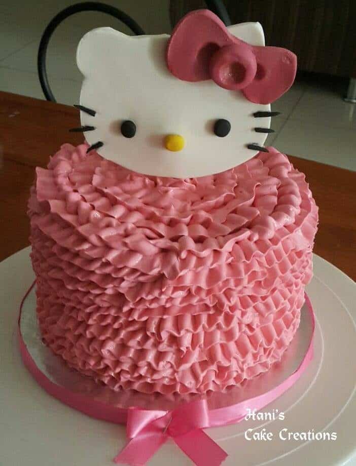 A round, single tier cake fully covered with ruffle buttercream icing with big Hello Kitty fondant cutout on top. Made by:  Hani's Cake Creations.Source
