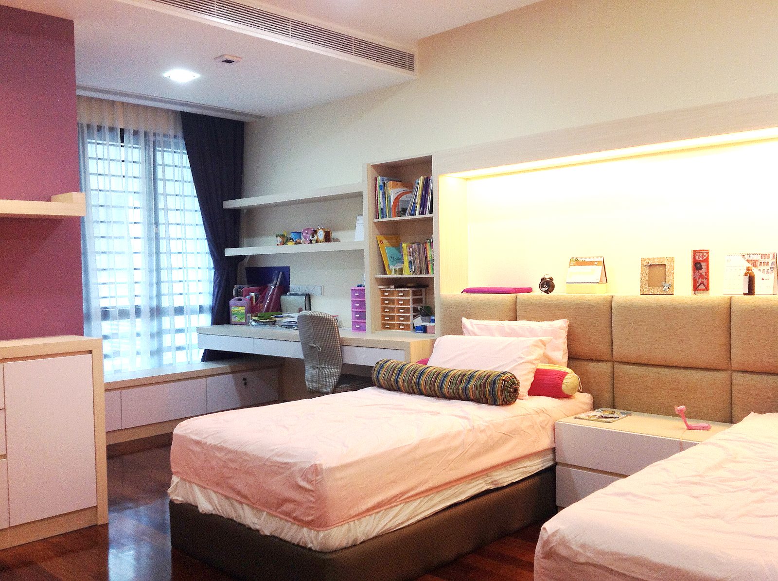 Teenager's bedroom design with integrated study area and display area above the beds in Bandar Kinrara 9, Puchong