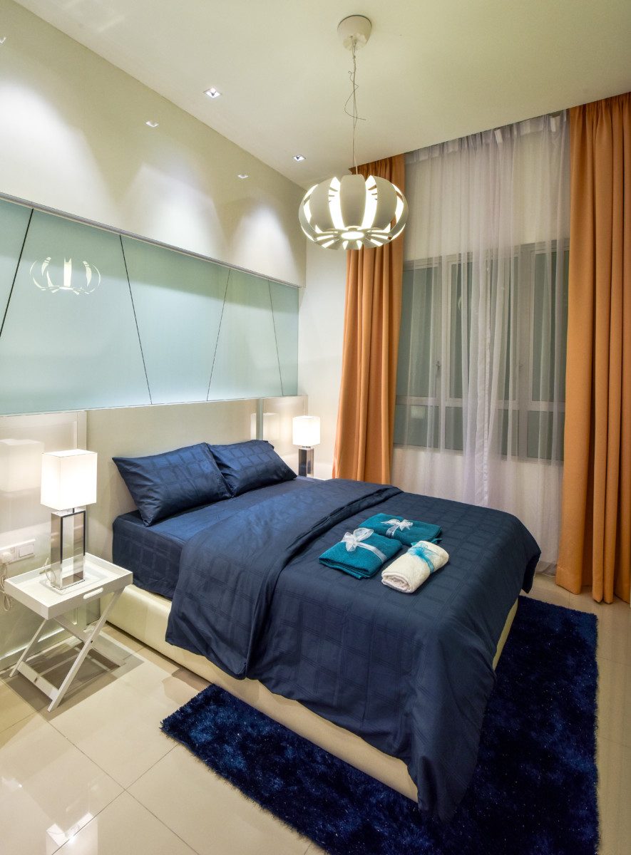 Modern bedroom with glass feature wall and pelmet ceiling lights for this condominium in Ceria Residence, Cyberjaya
