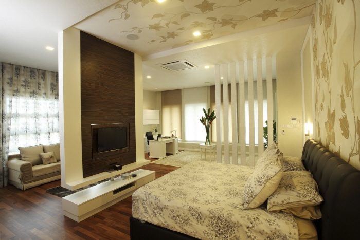 Leaf pattern wallpaper extended from headboard to ceiling in this bedroom in Rafflesia, Damansara Perdana
