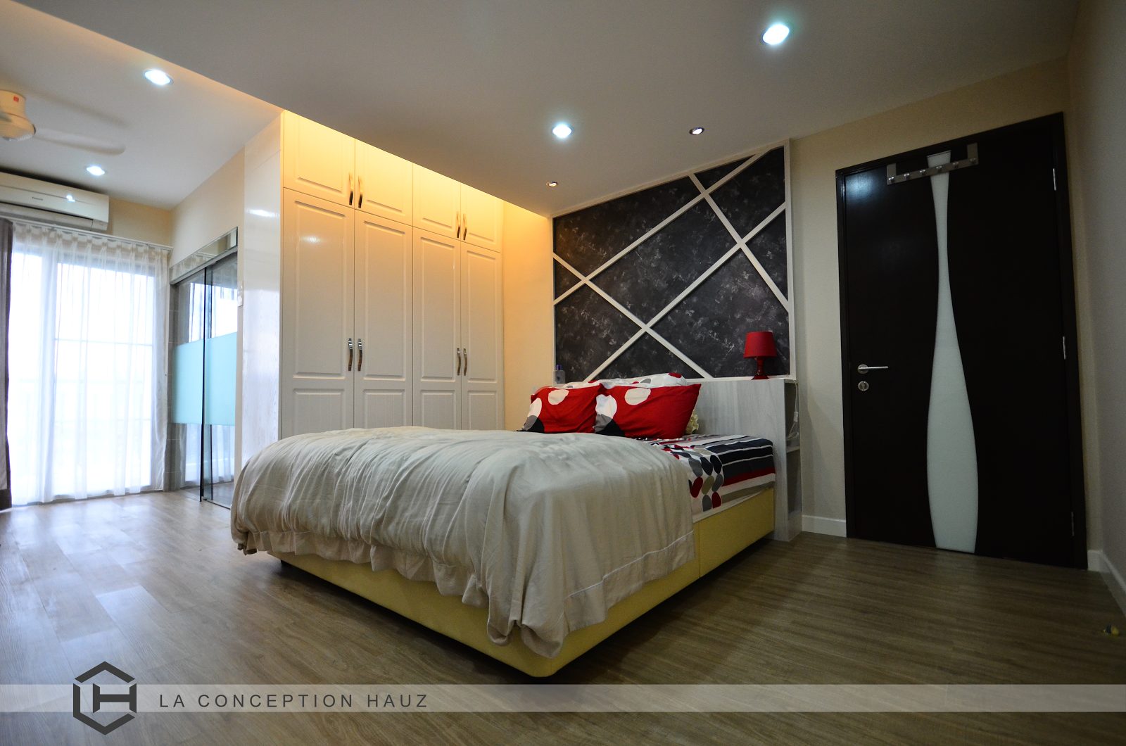 Rustic oak laminate floors and white wardrobe with raised panel doors for this condominium in Ampang Putra Residency